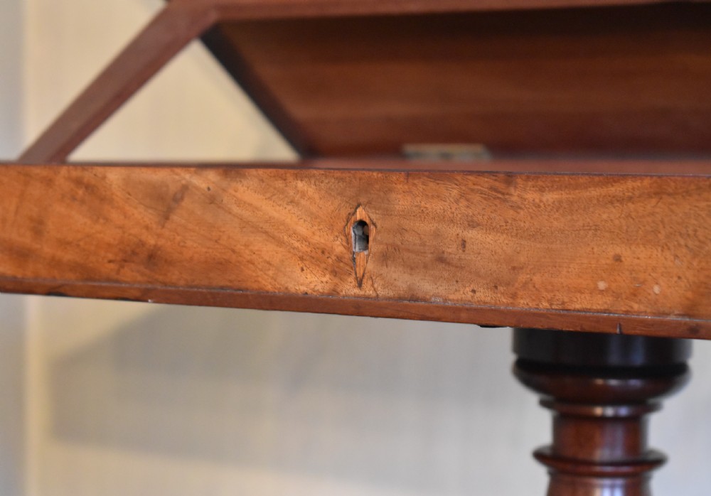 A Georgian mahogany library table featuring a rectangular leather-inset top supported by a turned pedestal stem and tripod swept legs. View V