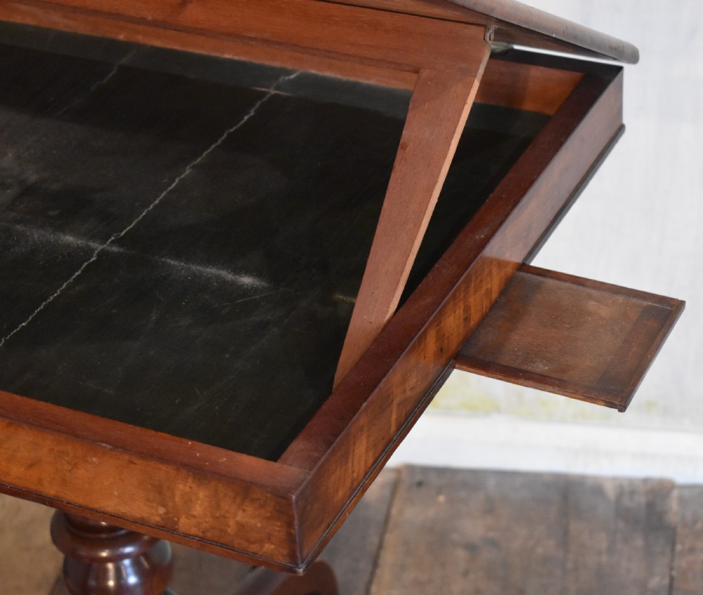 A Georgian mahogany library table featuring a rectangular leather-inset top supported by a turned pedestal stem and tripod swept legs. View VI