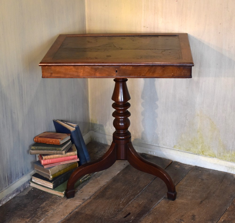 A Georgian mahogany library table featuring a rectangular leather-inset top supported by a turned pedestal stem and tripod swept legs. View VII
