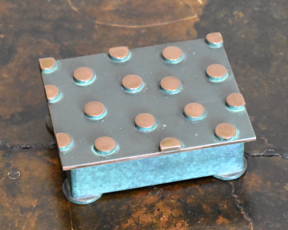 An Austrian Art Deco rectangular bronze box featuring a patinated verdigris green finish and lid adorned with raised circular copper studs.