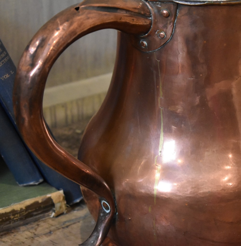 A large Georgian hand-hammered copper jug featuring a rounded baluster body, shaped pouring spout, heavy looped handle, and tin-lined interior. View III