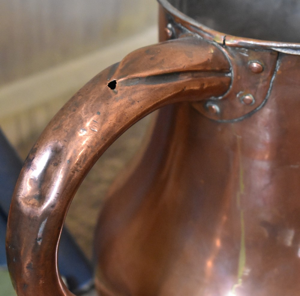 A large Georgian hand-hammered copper jug featuring a rounded baluster body, shaped pouring spout, heavy looped handle, and tin-lined interior. View IV