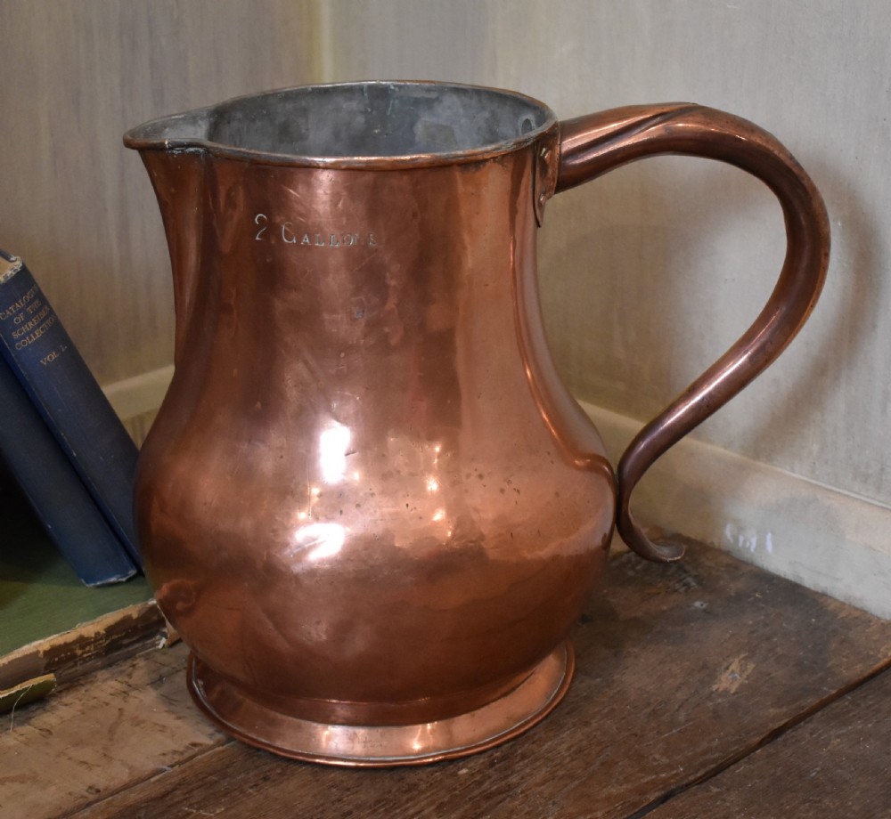 A large Georgian hand-hammered copper jug featuring a rounded baluster body, shaped pouring spout, heavy looped handle, and tin-lined interior. View V