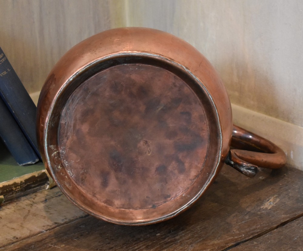 A large Georgian hand-hammered copper jug featuring a rounded baluster body, shaped pouring spout, heavy looped handle, and tin-lined interior. View VII