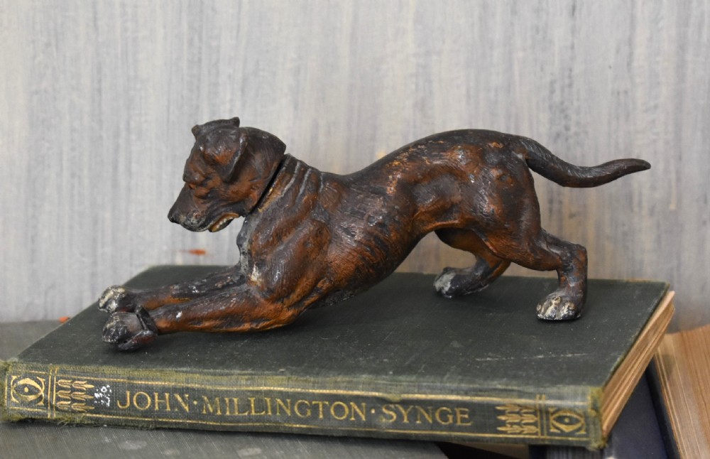 A cold painted spelter figurine depicting a dog in a playful stretching pose with an articulated nodding head mechanism. View II