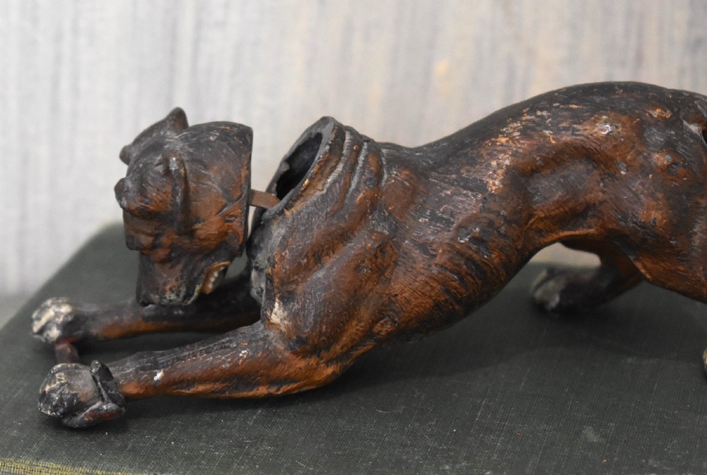 A cold painted spelter figurine depicting a dog in a playful stretching pose with an articulated nodding head mechanism. View III