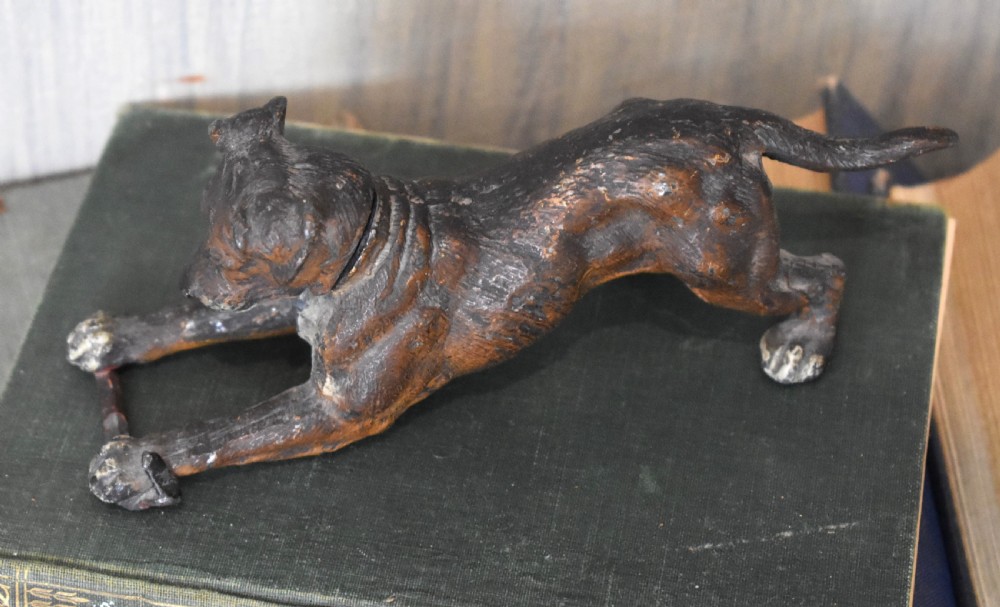 A cold painted spelter figurine depicting a dog in a playful stretching pose with an articulated nodding head mechanism. View V