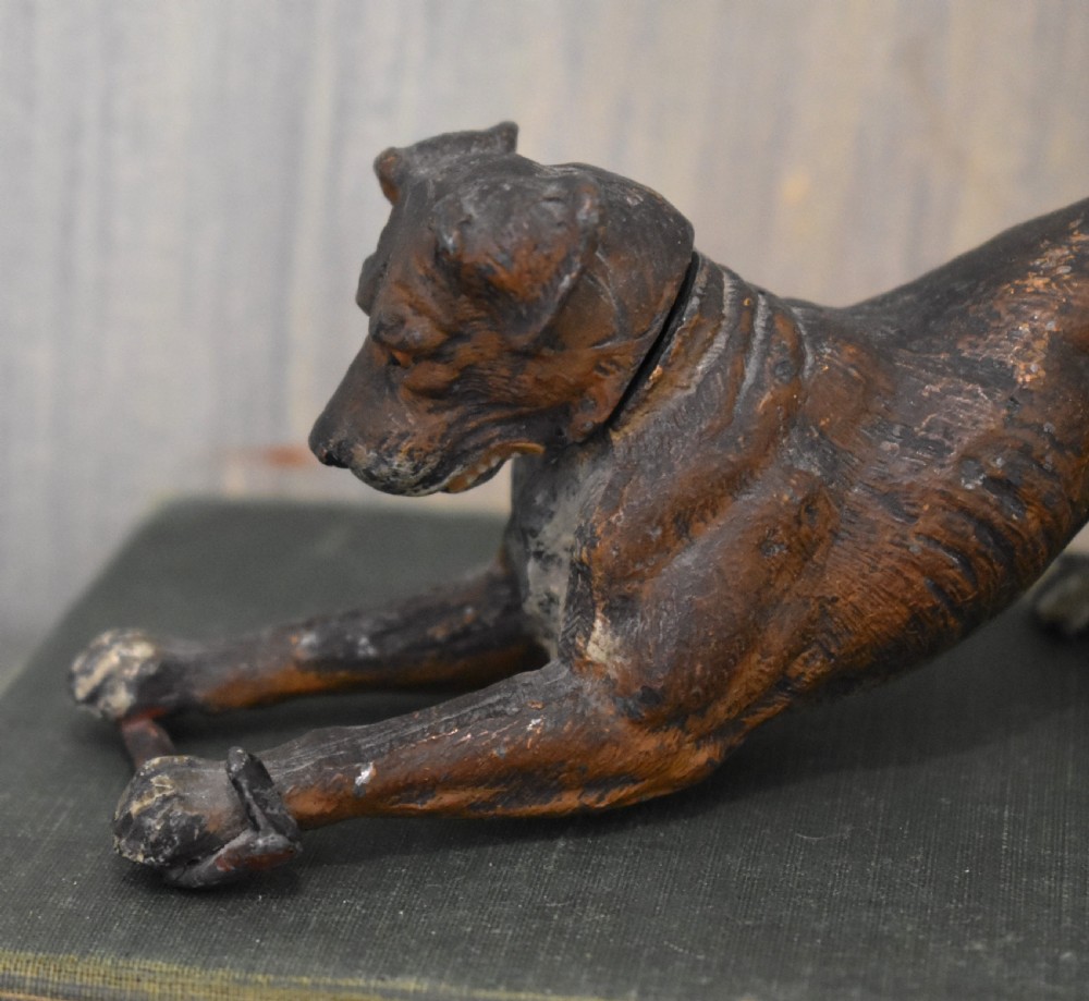 A cold painted spelter figurine depicting a dog in a playful stretching pose with an articulated nodding head mechanism. View VI