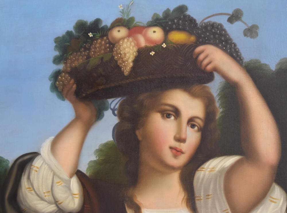 A portrait oil painting depicting a young woman carrying a basket of fruit on her head, set within an ornate carved gilt wood frame. View V