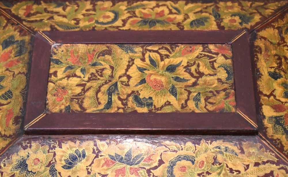 A rectangular Regency period wooden box featuring intricate botanical penwork decoration, brass ring handles, and ball feet. View VII