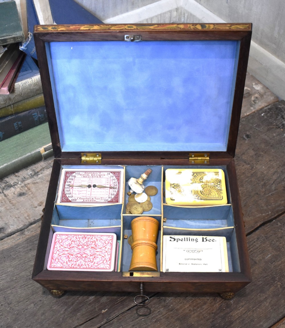 A rectangular Regency period wooden box featuring intricate botanical penwork decoration, brass ring handles, and ball feet. View VIII