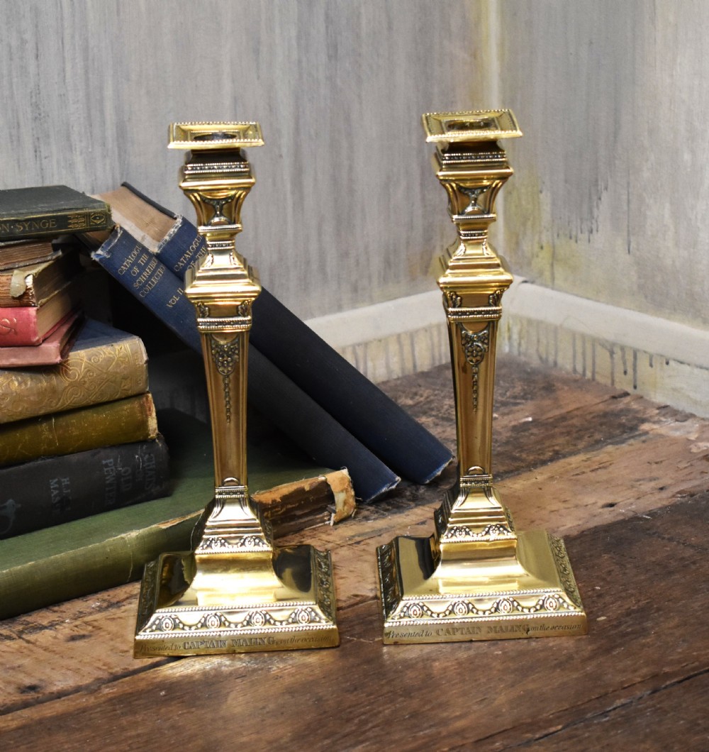 Pair of military related brass candlesticks