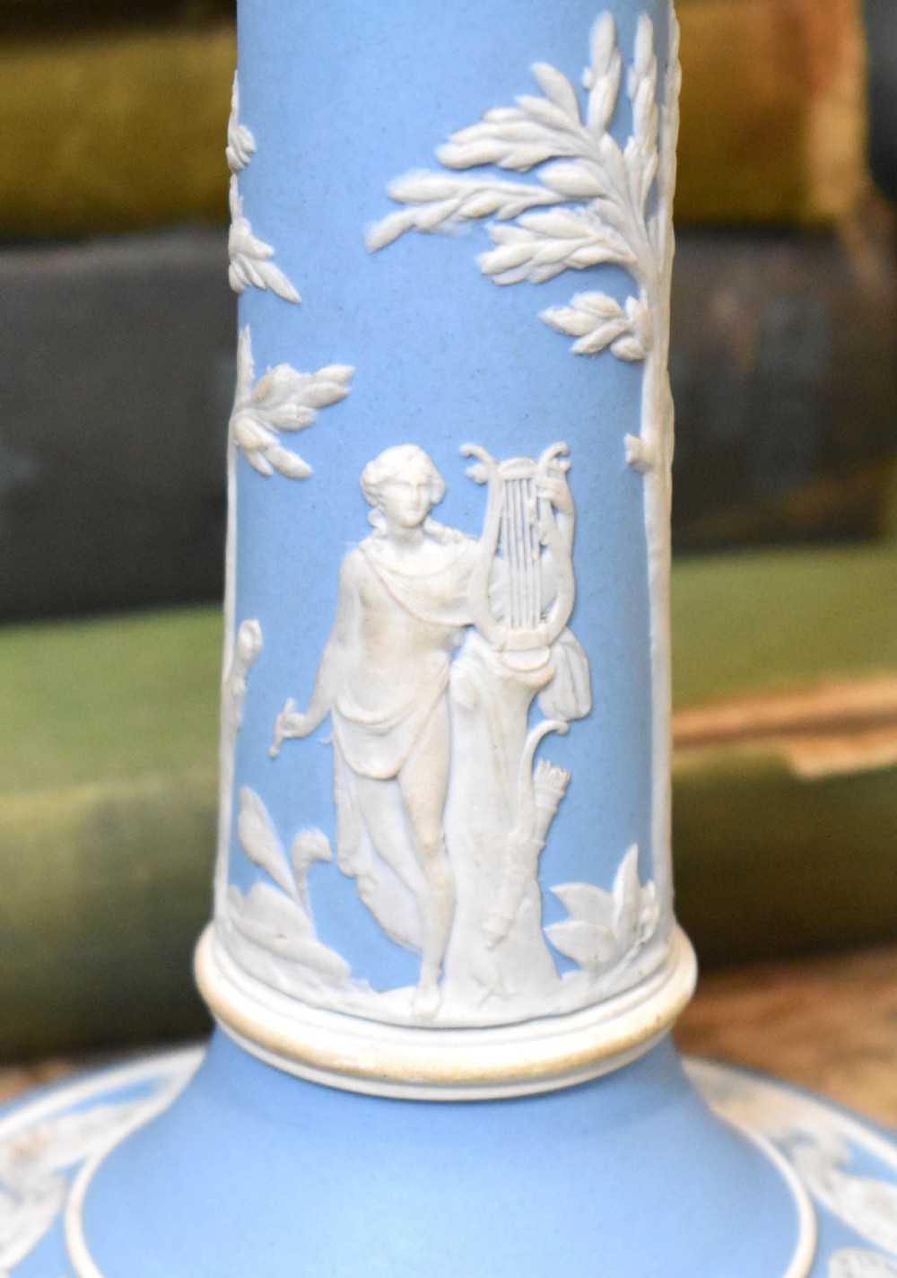 A pair of light blue Wedgwood jasperware candlesticks featuring white neoclassical bas-relief figures and classical floral bands on circular bases. View VI