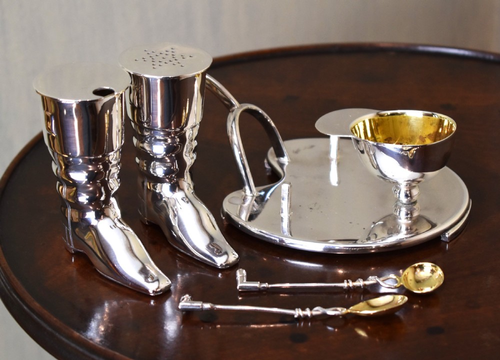 A silver-plated novelty equestrian cruet set featuring a riding boot mustard pot with a spur handle, a cap pepper shaker, and a gilt-lined salt cellar on a fitted tray. View III