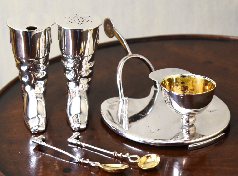 A silver-plated novelty equestrian cruet set featuring a riding boot mustard pot with a spur handle, a cap pepper shaker, and a gilt-lined salt cellar on a fitted tray. View IV