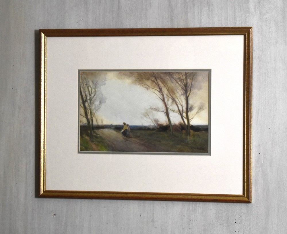 A framed antique watercolour landscape painting depicting a rural path lined with bare trees under a twilight sky.