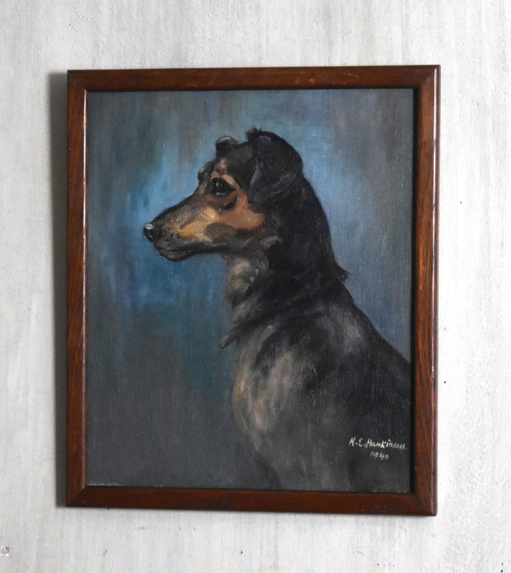 A profile view oil painting depicting a black and tan dog set against a textured blue background within a dark wooden frame.