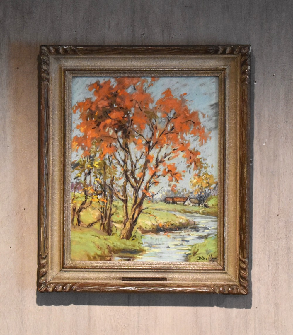 A framed original pastel landscape painting depicting autumn trees with orange foliage beside a winding river by Berthe des Clayes.