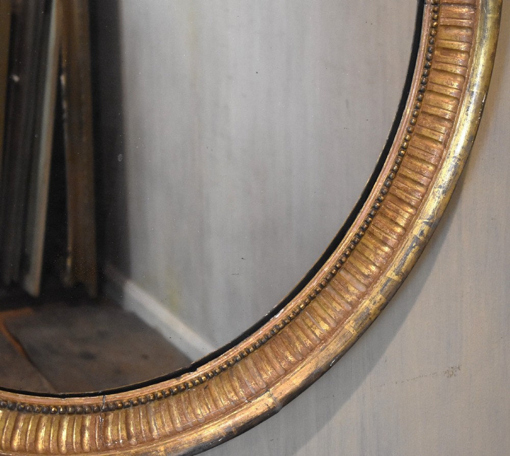 Large early nineteenth century oval gilt mirror View III