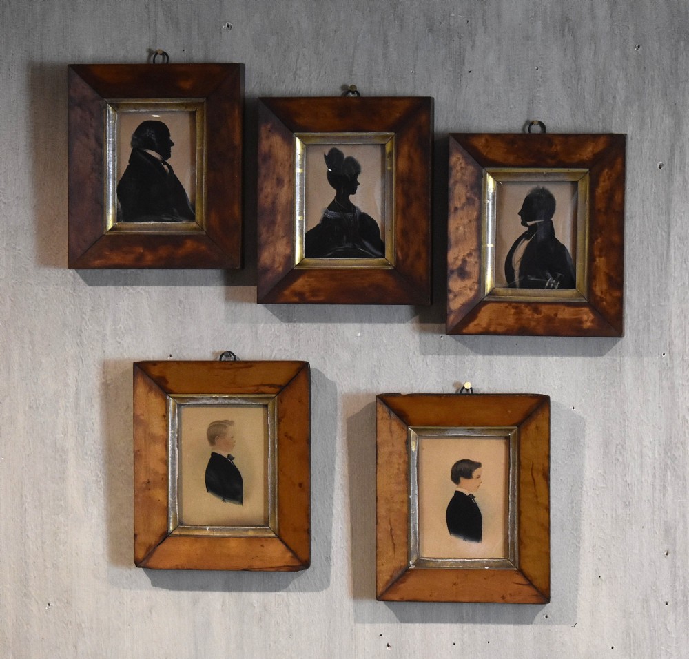 A set of five family silhouettes