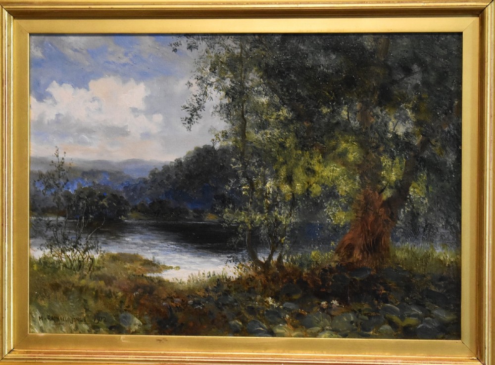A framed oil painting depicting a tranquil river scene with leafy green trees, distant hills, and a cloudy blue sky, encased in a gold gilded wooden frame. View III