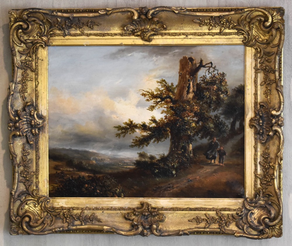 A nineteenth-century French oil painting depicting figures beside a prominent oak tree in a atmospheric rural landscape, presented in a ornate gilded gesso frame. View II