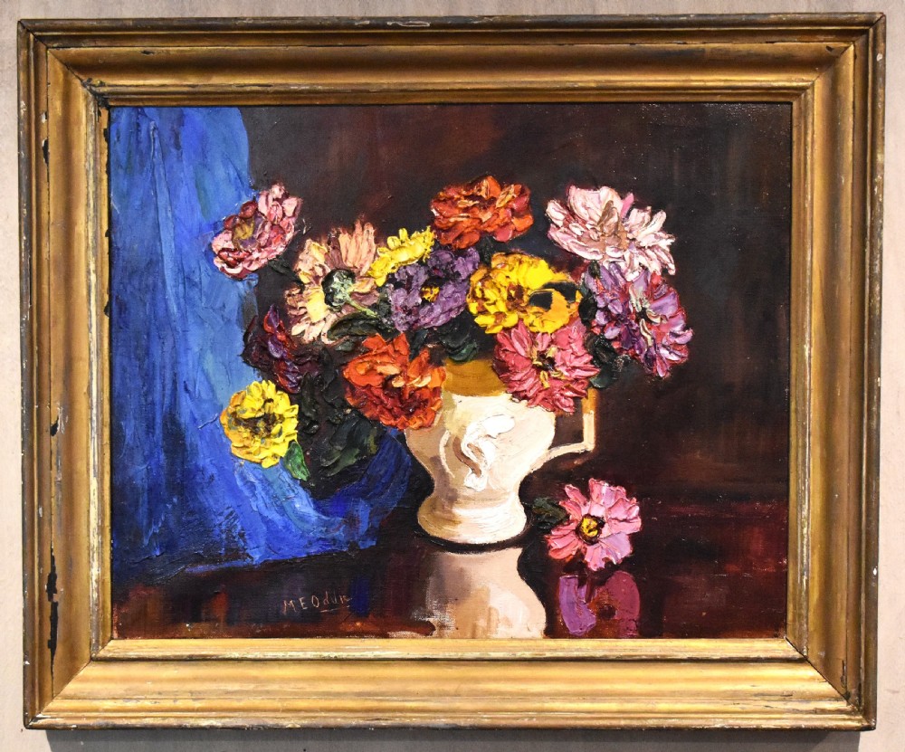 A framed oil painting featuring a vase filled with colourful flowers beside a draped blue cloth set against a dark background. View II