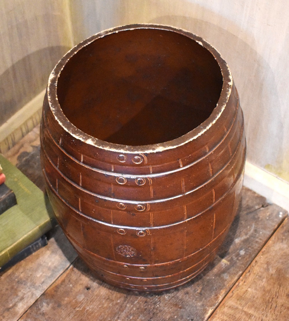 A large dark brown saltglaze stoneware stick stand moulded in the shape of a barrel with simulated staves and metal hoops. View III