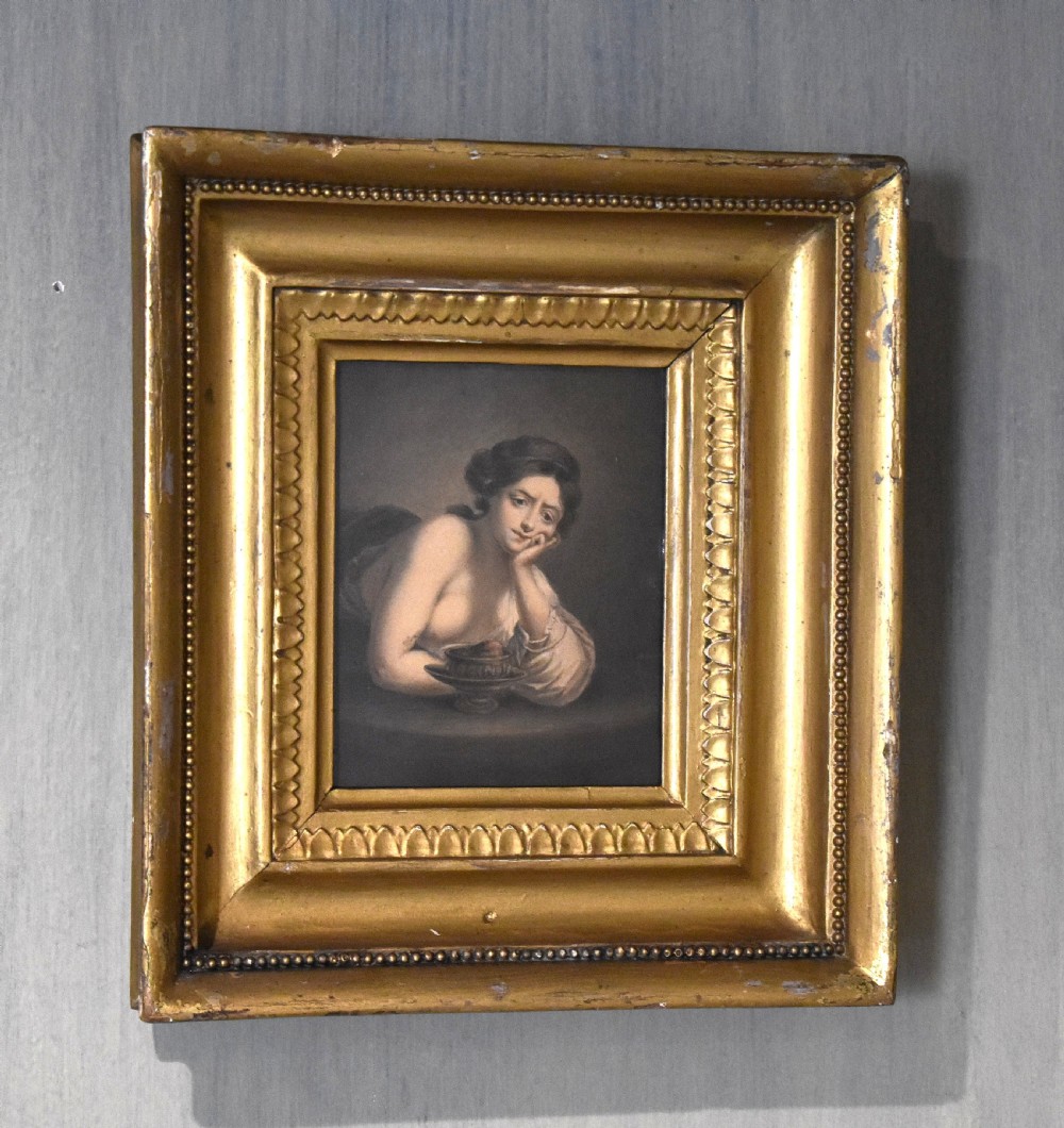 A Georgian watercolour portrait depicting a female figure resting her face on her hand, enclosed within a deep gilded wood frame.