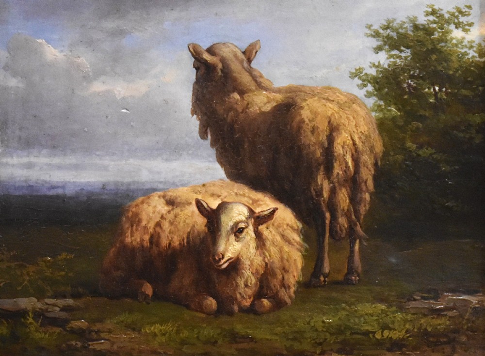 A small 19th-century pastoral oil painting depicting two sheep in a landscape, set within an ornate gilded frame with scrolled corner detailing. View IV