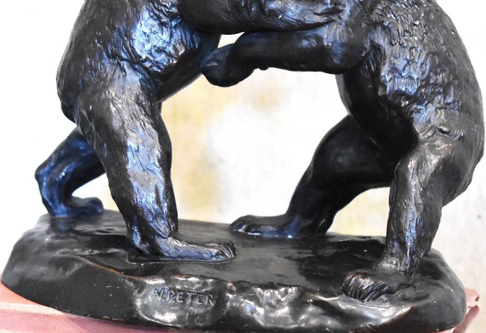 A dark patinated bronze sculpture depicting two play-fighting bear cubs standing on an integral naturalistic bronze base. View III