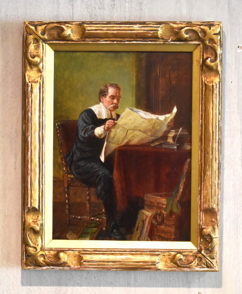 A 19th-century oil painting by John Watkins Chapman depicting a man in historic dress reading at a desk, mounted inside a gilded frame.