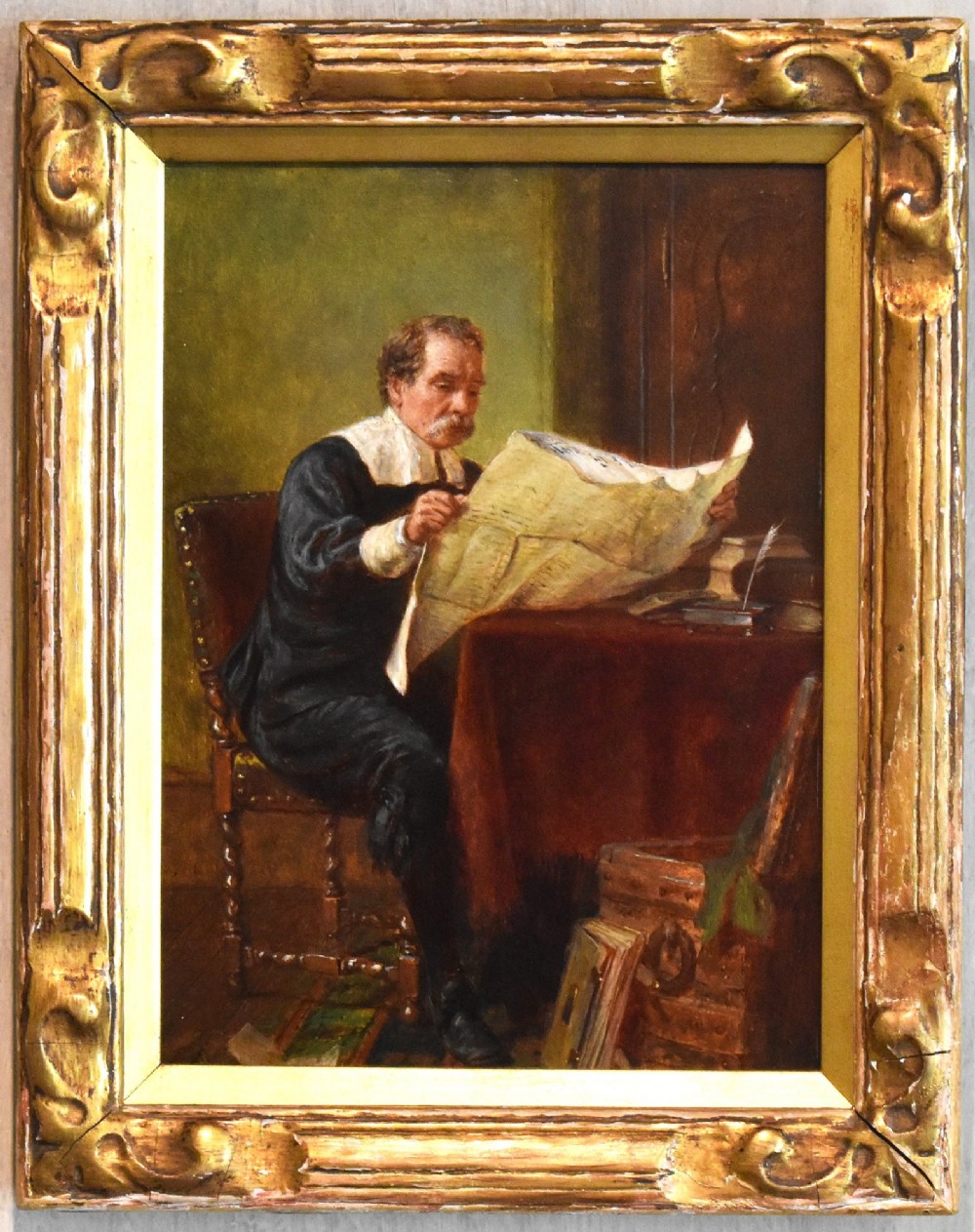A 19th-century oil painting by John Watkins Chapman depicting a man in historic dress reading at a desk, mounted inside a gilded frame. View II