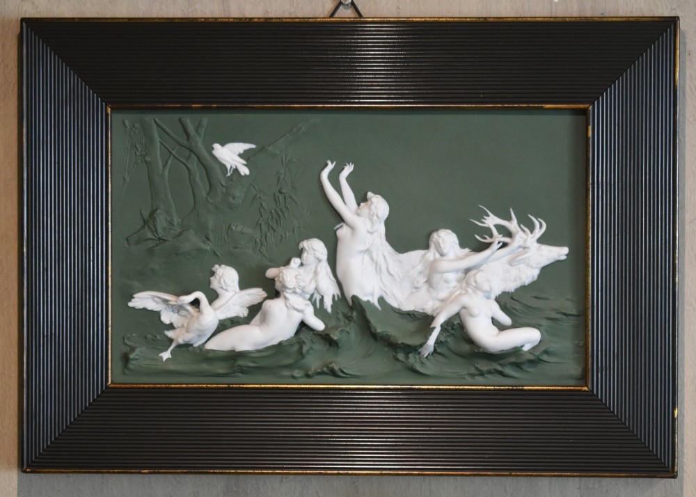 A pair of framed Art Nouveau Dresden porcelain plaques featuring white high-relief mythological figures on a dark green ground within reeded black frames. View V