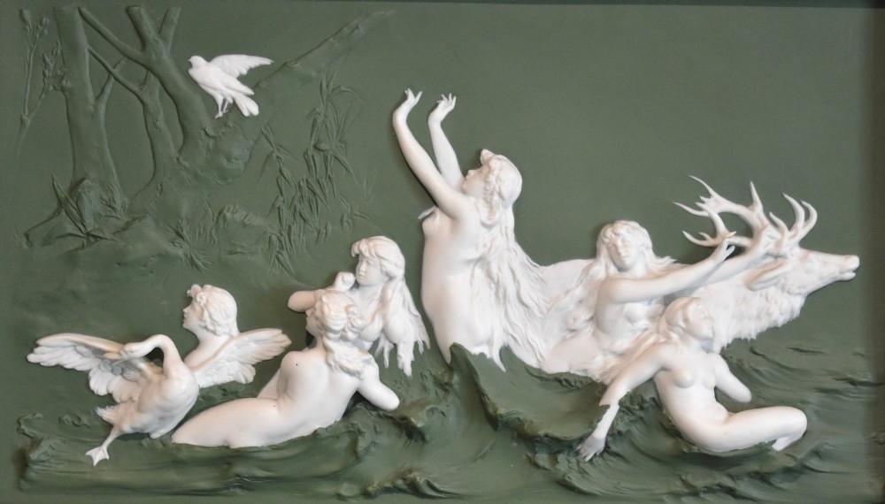 A pair of framed Art Nouveau Dresden porcelain plaques featuring white high-relief mythological figures on a dark green ground within reeded black frames. View VI