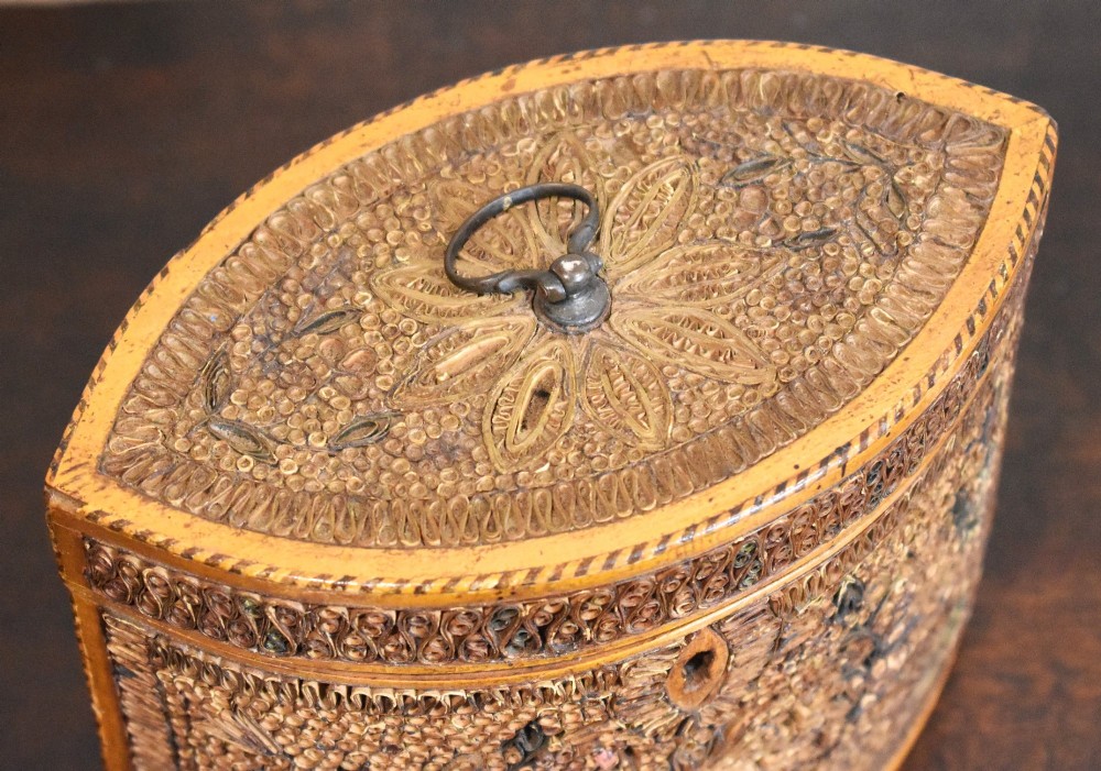 A late 18th-century Georgian navette-shaped tea caddy covered entirely in tight quilled paper scrolls with central floral panels. View III