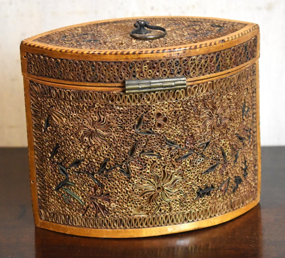 A late 18th-century Georgian navette-shaped tea caddy covered entirely in tight quilled paper scrolls with central floral panels. View IV