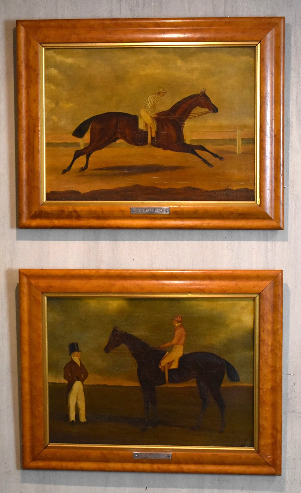A vertical pair of framed antique sporting prints depicting racehorses and jockeys set in golden maple frames with brass title plaques. View II