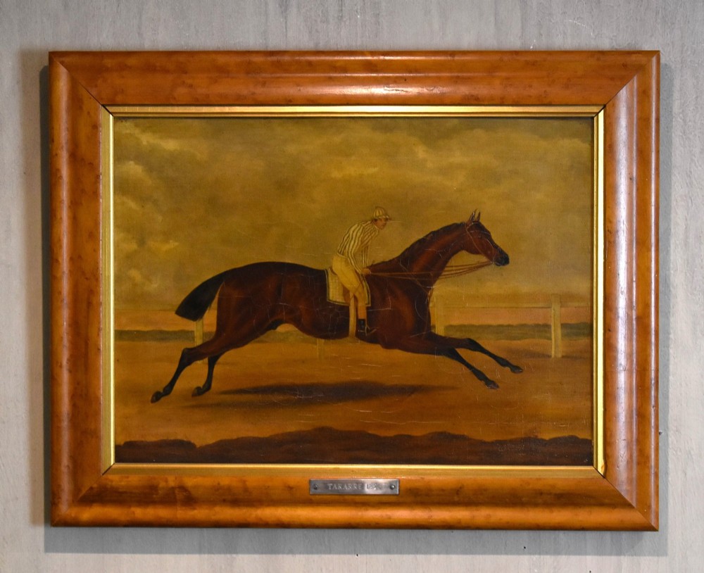 A vertical pair of framed antique sporting prints depicting racehorses and jockeys set in golden maple frames with brass title plaques. View III