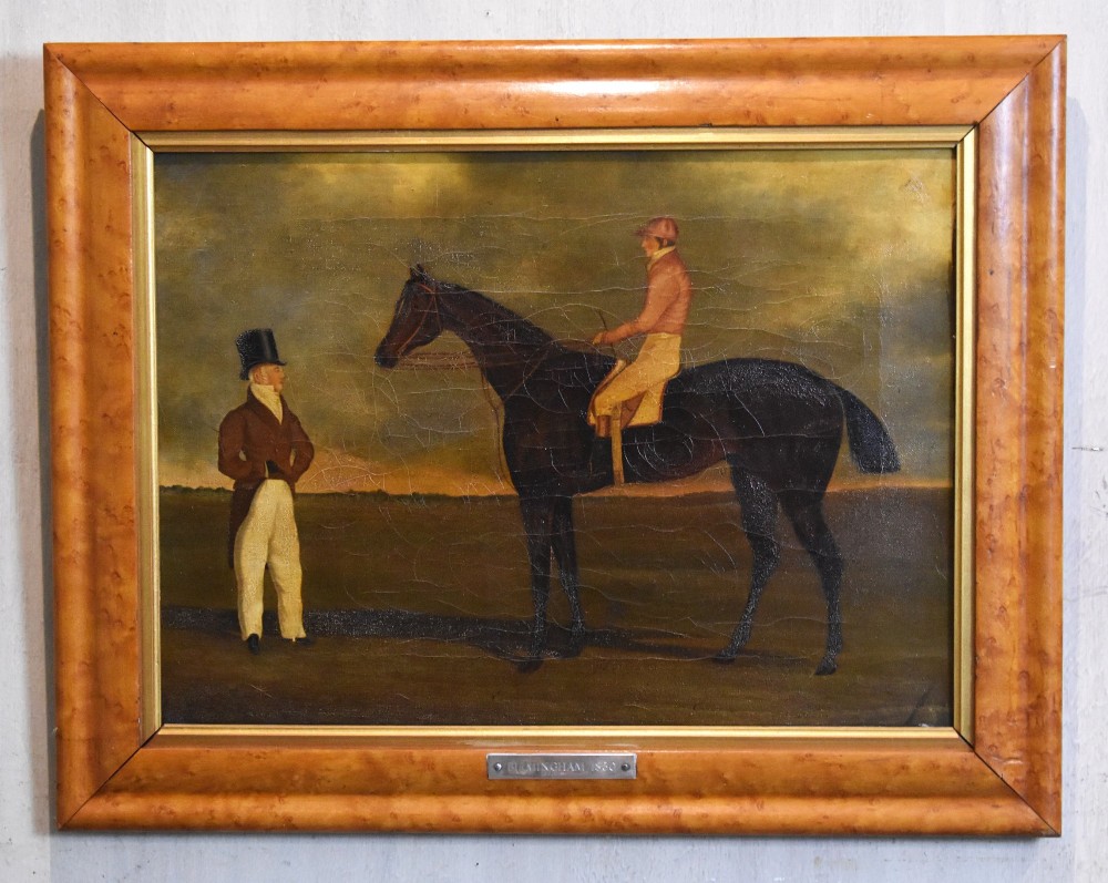 A vertical pair of framed antique sporting prints depicting racehorses and jockeys set in golden maple frames with brass title plaques. View V