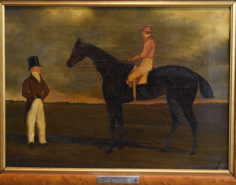 A vertical pair of framed antique sporting prints depicting racehorses and jockeys set in golden maple frames with brass title plaques. View VI