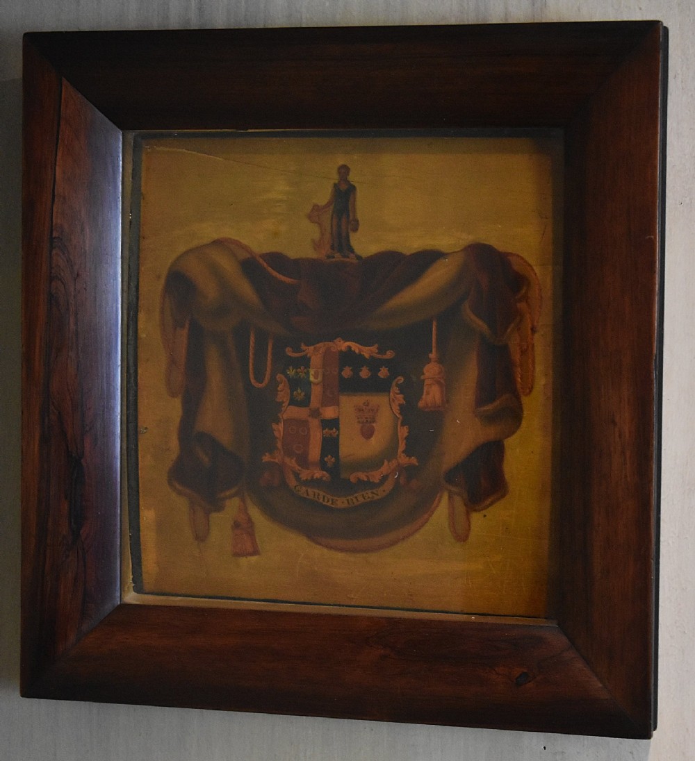 An antique Georgian painted wooden coach panel featuring a heraldic coat of arms within a thick dark mahogany frame. View II