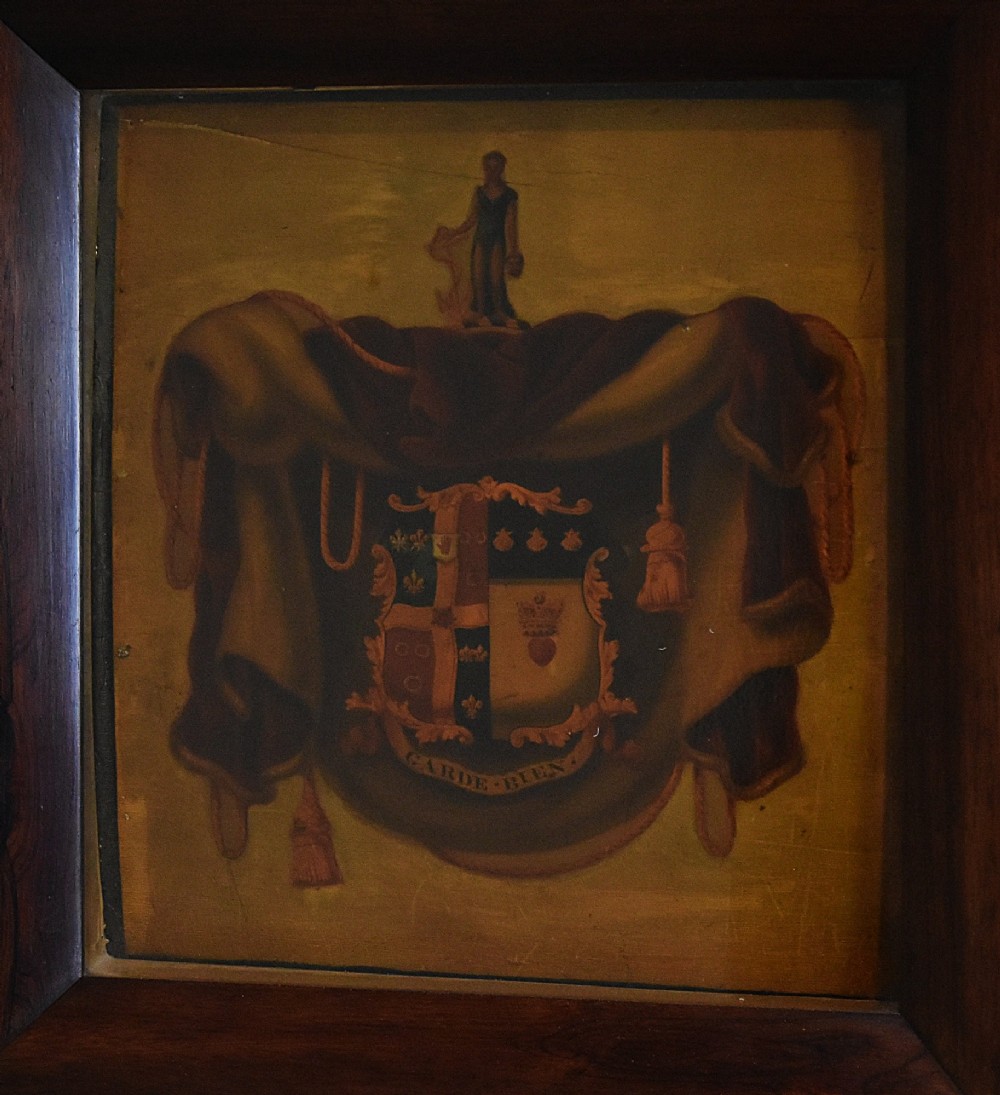 An antique Georgian painted wooden coach panel featuring a heraldic coat of arms within a thick dark mahogany frame. View III