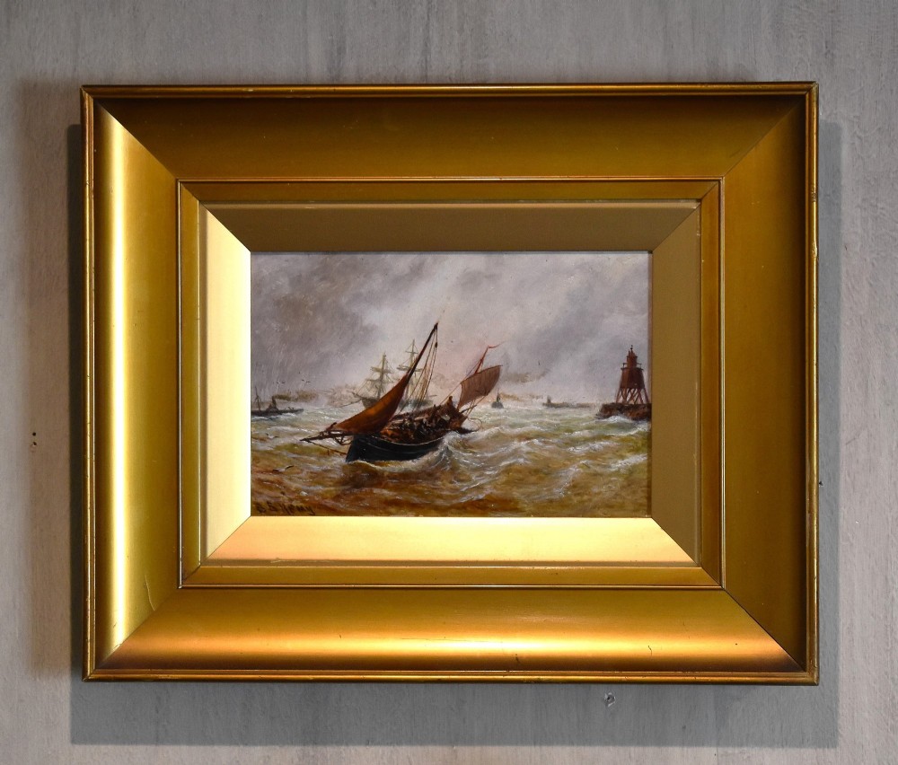 A framed 19th-century marine oil painting depicting sailing vessels navigating choppy seas near a beacon under a cloudy sky.