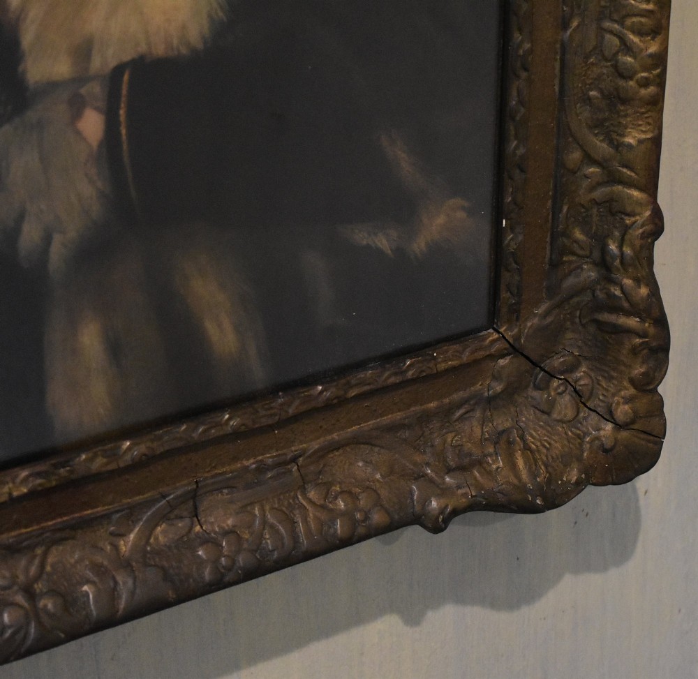 A framed portrait print depicting a young man in a red cap and fur-trimmed coat after Titian, set inside a carved gilt frame. View VI