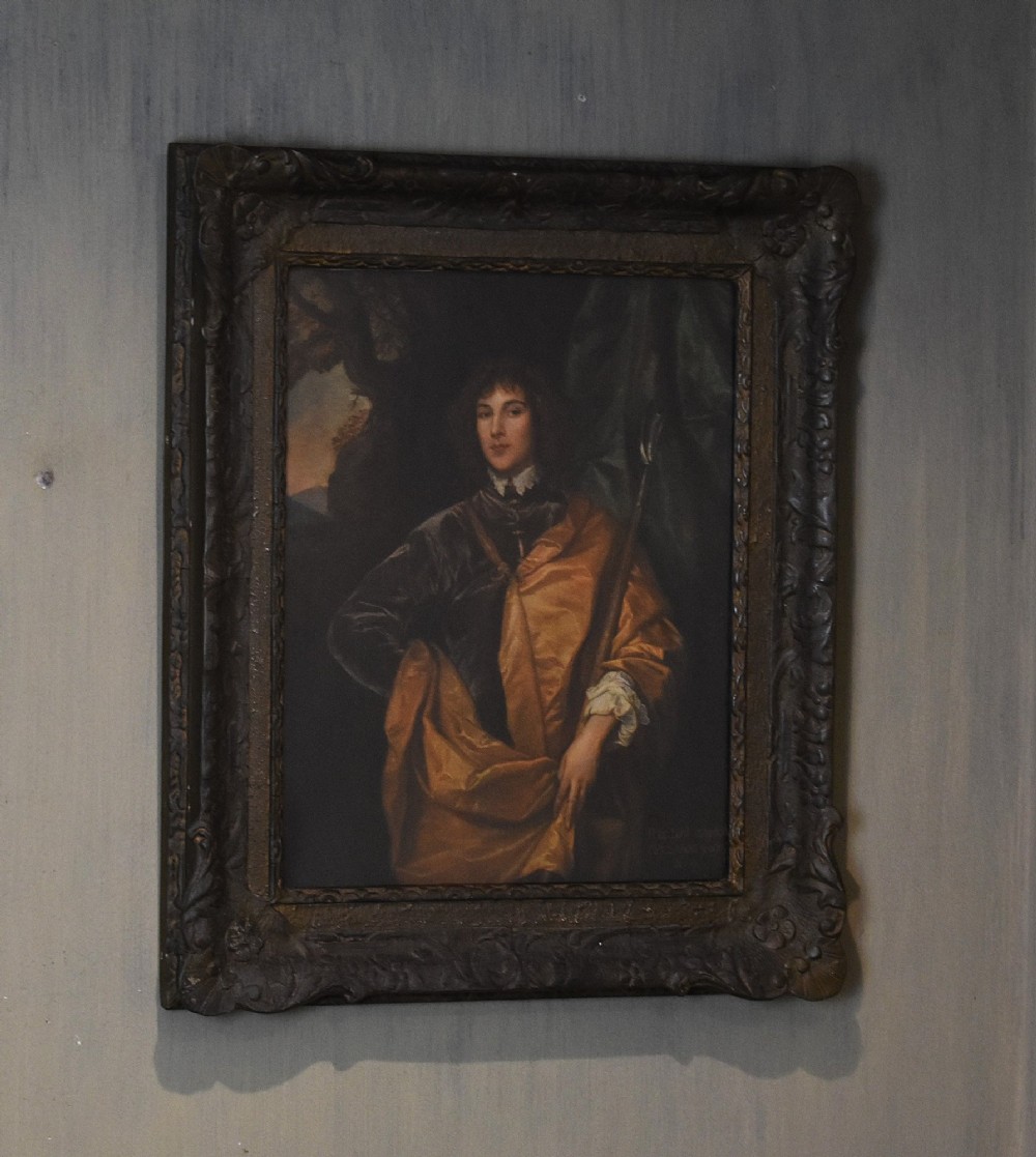 A framed portrait print depicting Philip, Lord Wharton, draped in an amber cloak against a dark background, set within a carved dark wood frame.