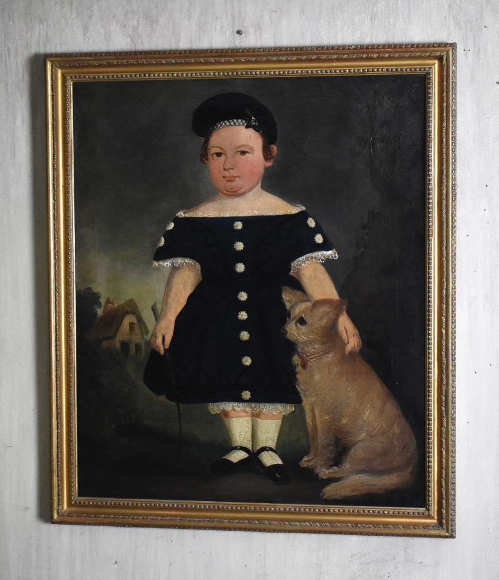A 19th-century Victorian folk-art oil painting depicting a young child in a dark dress standing beside a small brown dog, enclosed in a gilded wooden frame.