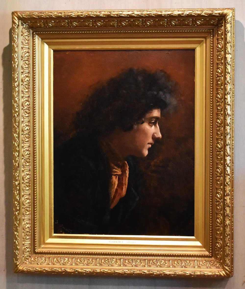 An antique Victorian profile oil painting depicting a figure with dark curly hair set within an ornate gilded frame. View II