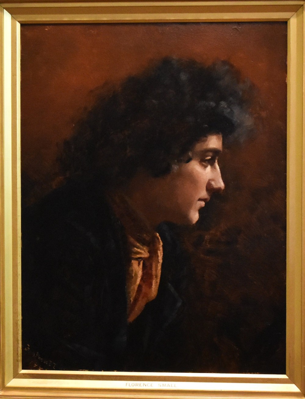 An antique Victorian profile oil painting depicting a figure with dark curly hair set within an ornate gilded frame. View III