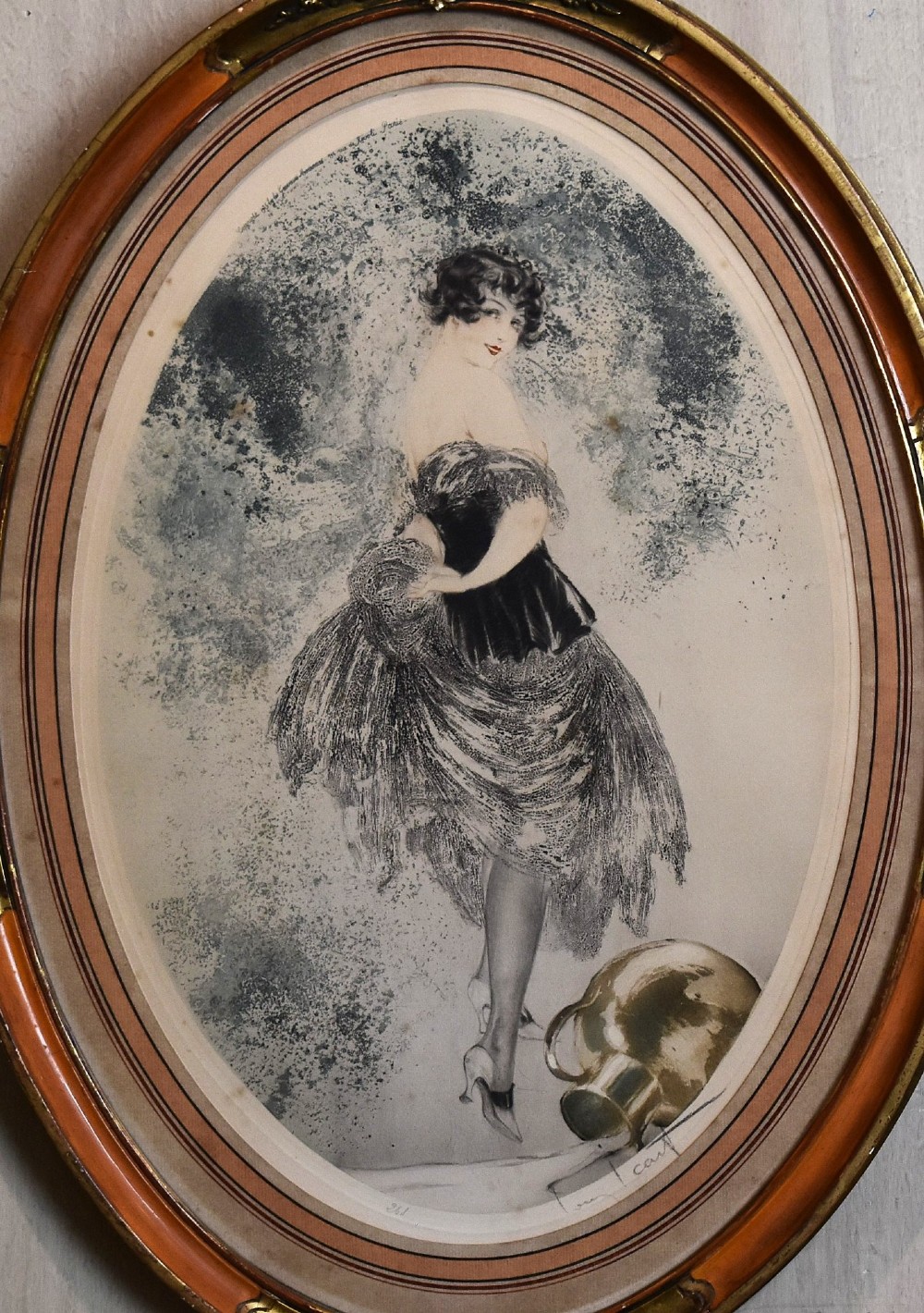 A set of three framed Art Deco fashion prints by Louis Icart featuring figures in 1920s gowns, presented in two oval and one rectangular gilt frames. View VIII